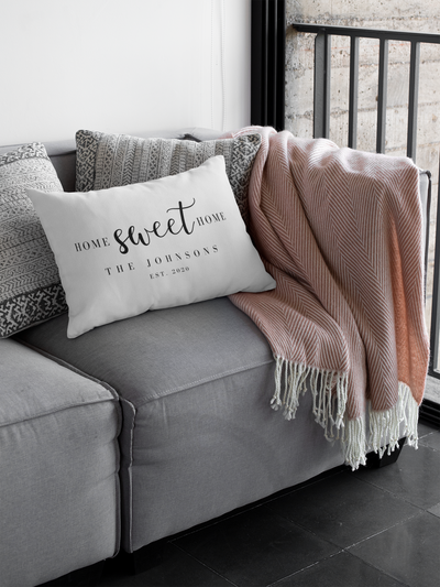 personalized real estate pillow as real estate closing gift laying on couch